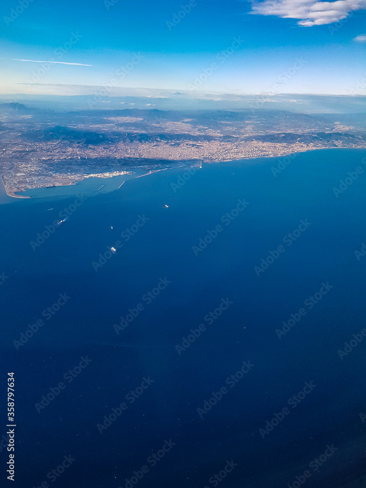 Depart start fly Barcelona view from the top air down the city port sea ocean Barcelona blue water sky landscape spain
