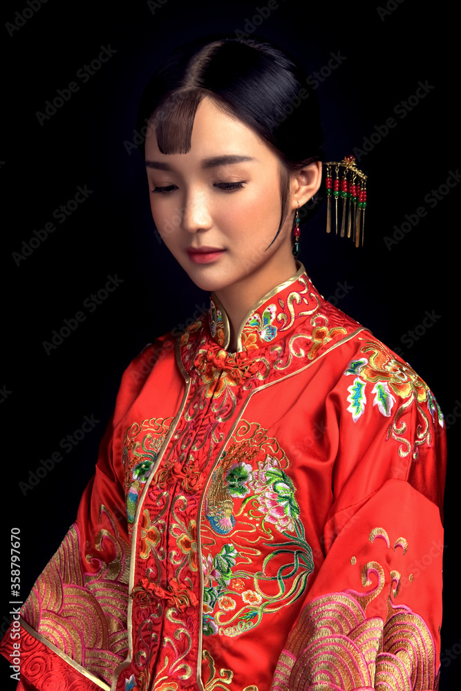 Bride in Asian costume in black background Bride in Asian costume in black background
