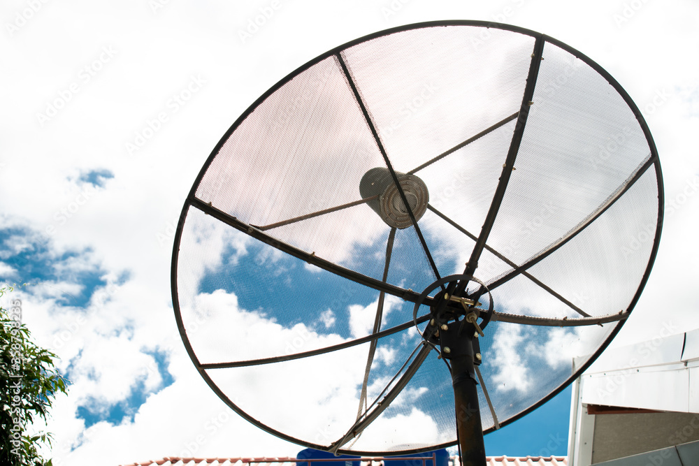 TV television satellite dish on the roof with blue and paper like white cloud background