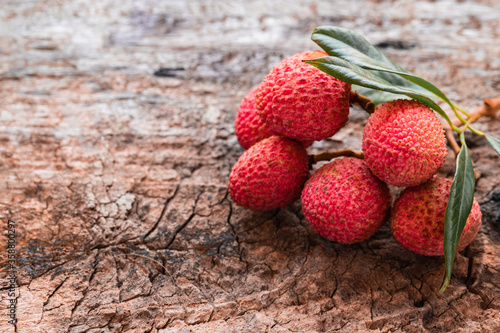 Lychee with leaves on gray background. Tropical fruit. photo