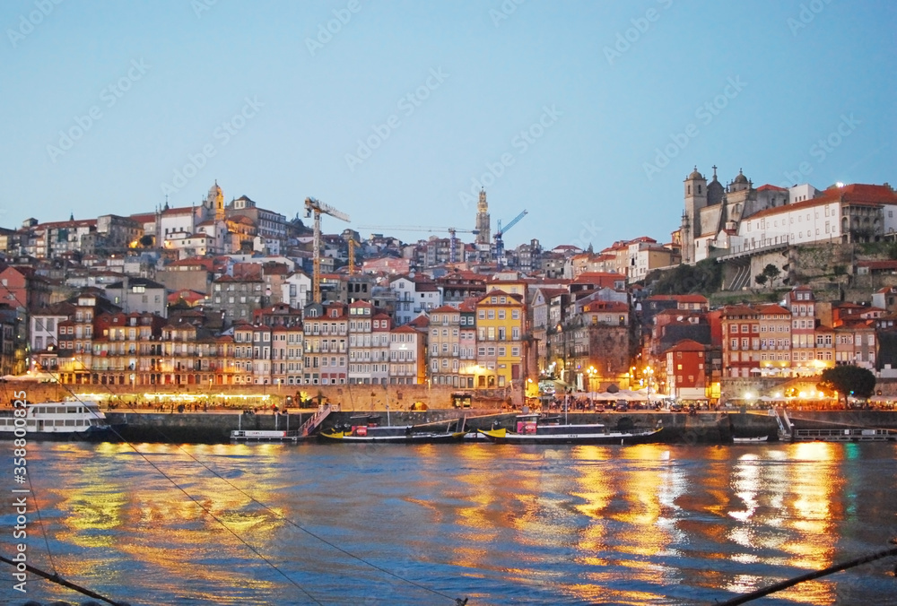 Downtown Porto city lights and Douro river during twilight seen from Vila Nova de Gaia, Portugal