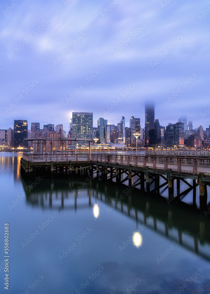 View on Midtown Manhattan from East river pier on a foggy morning with long exposure