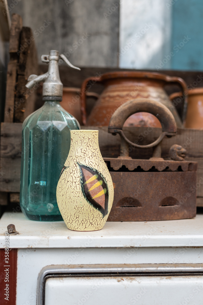 Midcentury modern ceramic vase and vintage decor pieces in interior