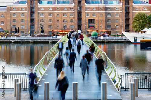 North Dock Footbridge from Canary Wharf to West India Quay in London with unidentified crossing people photo
