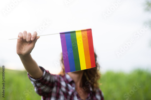 woman holding rainbow flag LGBT rights