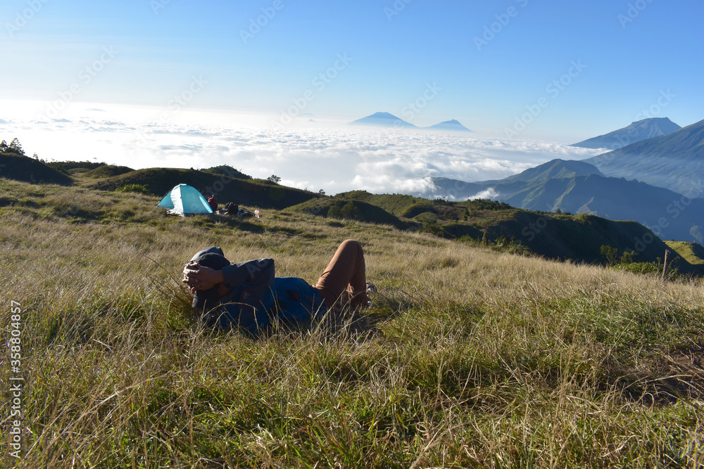 Hiker enjoying mountains view, Prau Mountain, Central Java