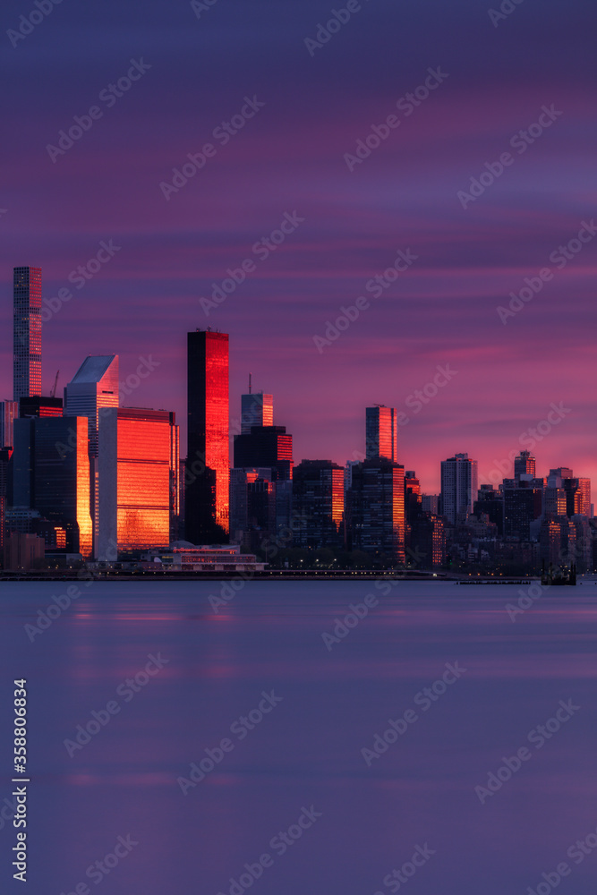 Fototapeta premium View on Midtown Manhattan skyscrapers during red sunlight with long exposure