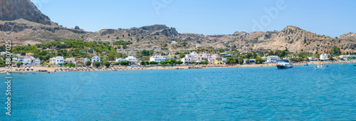 Fototapeta Naklejka Na Ścianę i Meble -  Panoramic view of Stegna beach with apartment houses close to Town of Archangelos (RHODES, GREECE)