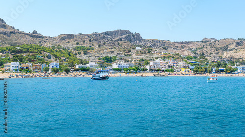 Fototapeta Naklejka Na Ścianę i Meble -  Panoramic view of Stegna beach with anchored tourist boats (RHODES, GREECE)