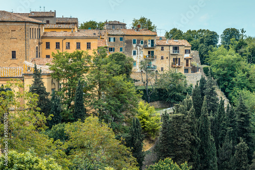 Residential houses of the old town built on a steep slope in a popular hilltop town of Volterra, Tuscany, Italy, seen from Piazza XX Settembre.