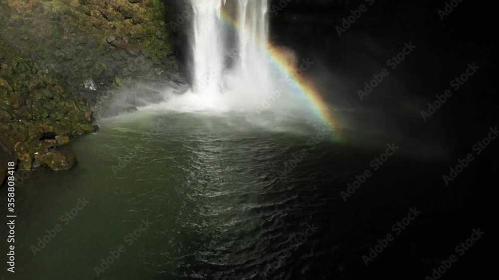 Panning up shot of Gorogotaki waterfall on the island Kyushu in the town Yamato in Japan. The waterfall creates a beautiful rainbow in the sunlight. Panning up shot of Gorogotaki waterfall on the island Kyushu in the town Yamato in Japan. The waterfall creates a beautiful rainbow in the sunlight.
