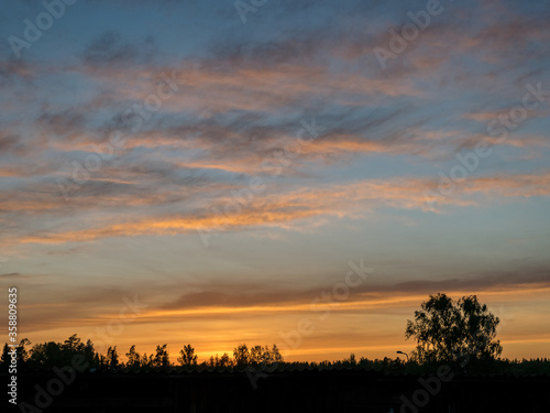 landscape with colorful sunset sky over the roof