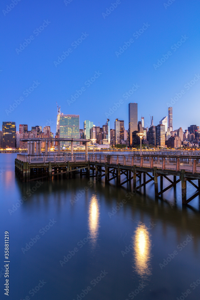 Midtown Manhattan view from East River Pier at dawn with long expsoreu