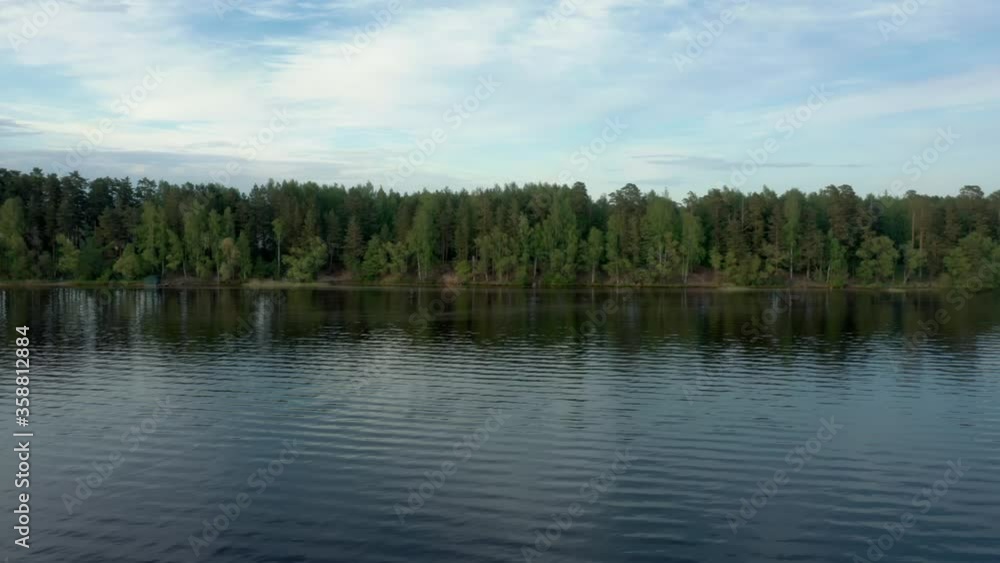 Lake Bezdonnoe drone pan shot left to right in Moskovskaya oblast' under cloudy sky. Botomless lake high quality 4k footage aerial shot of lake in Moscow with a horizon of green forest Lake Bezdonnoe drone pan shot left to right in Moskovskaya oblast' under cloudy sky. Botomless lake high quality 4k footage aerial shot of lake in Moscow with a horizon of green forest