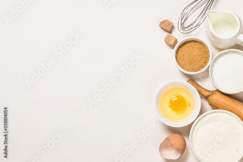 Baking ingredients at blue table top view.