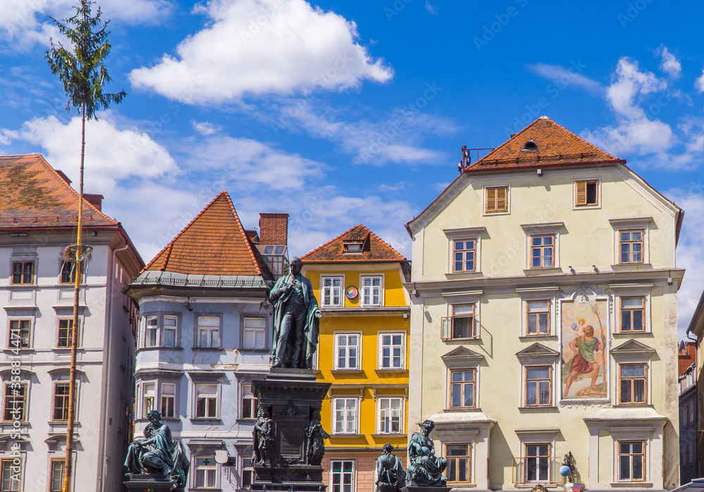 Medieval statues in front of traditional Austrian houses on Hauptplatz (main square) in Graz, Austria