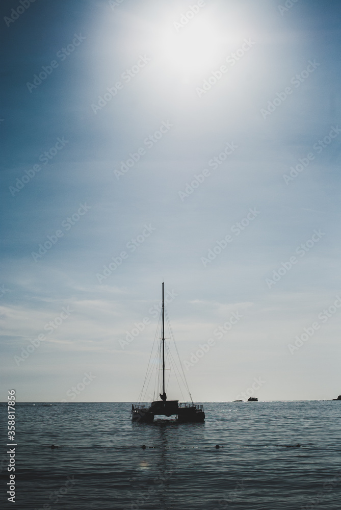 Silueta de bote en el mar con el sol saliente