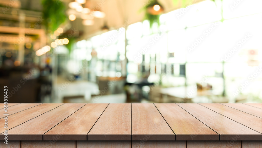 Empty wooden table top with lights bokeh on blur restaurant background