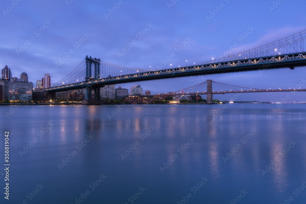 View on Dumbo location from East River with long exposure at dawn