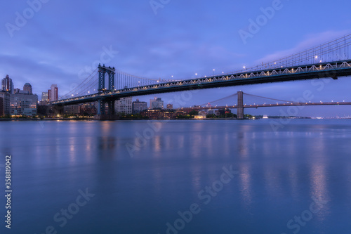 View on Dumbo location from East River with long exposure at dawn