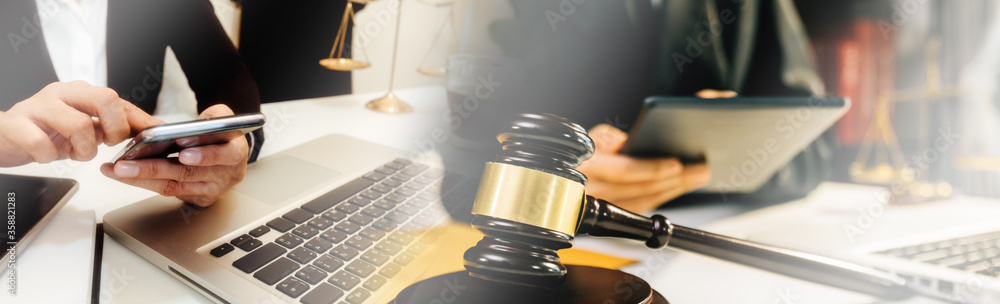 Business and lawyers discussing contract papers with brass scale on desk in office. Law, legal services, advice, justice and law concept . Business and lawyers discussing contract papers with brass scale on desk in office. Law, legal services, advice, justice and law concept .