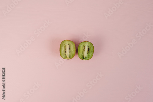 Flat Lay of Kiwi Lying on the Pink Background Table