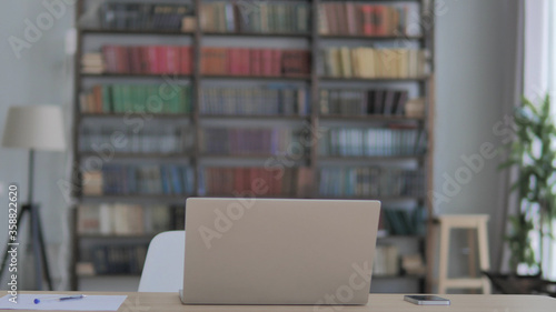 Empty Creative Office with Open Laptop on Desk photo