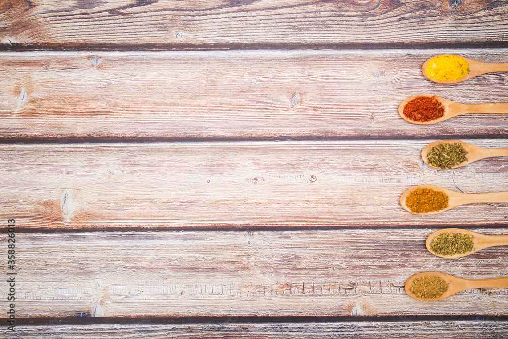 Various kind of spices for food in wooden zero waste spoons. Organic healthy concept Various kind of spices for food in wooden zero waste spoons. Organic healthy concept