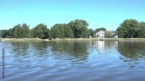 View over the water to the north shore of the Steinhuder Lake near Hannover, Germany, with a jetty and a house photo