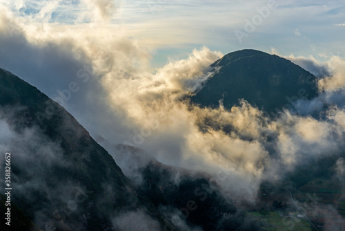 Fog at sunset in the Pululahua volcanic crater, Quito, Ecuador.