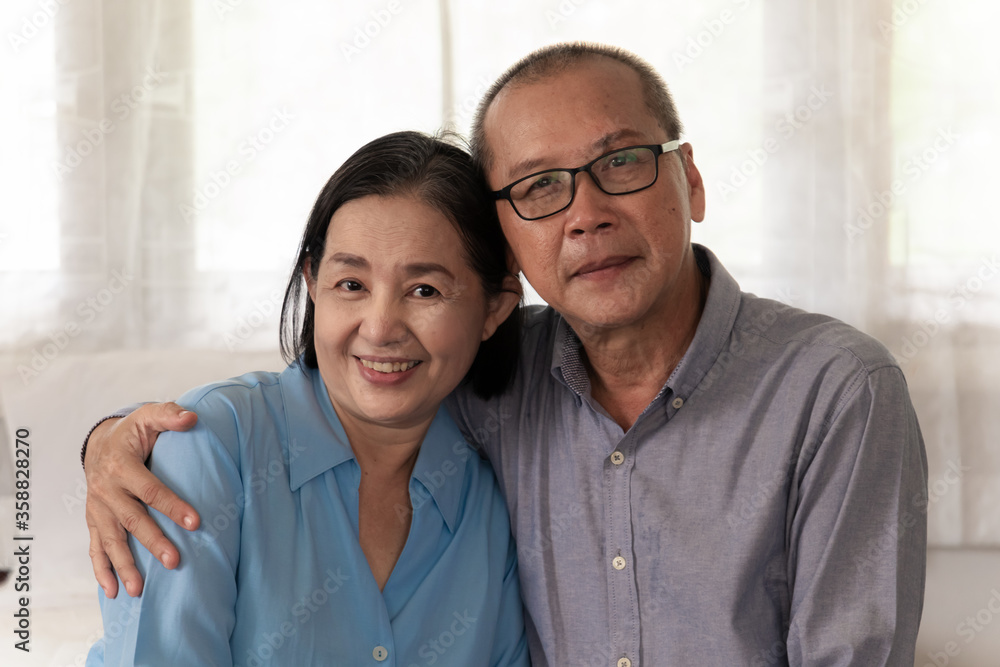 Elderly couple hugging on bed in bedroom with love and smiles. Elderly couple hugging on bed in bedroom with love and smiles.