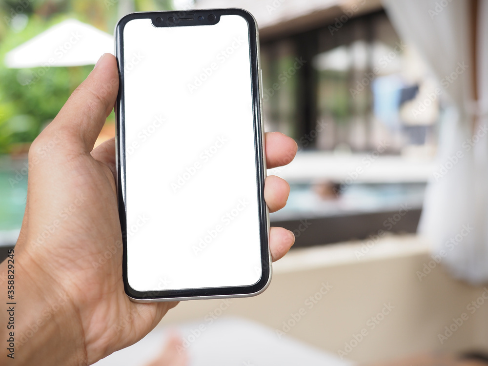 Holding Mobile Smart Phone In Hand at swimming pool. Phone screen in white color for die cut. Holding Mobile Smart Phone In Hand at swimming pool. Phone screen in white color for die cut.