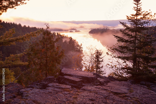 Northern Minnesota lake viewed from a rocky cliff at dawn during autumn