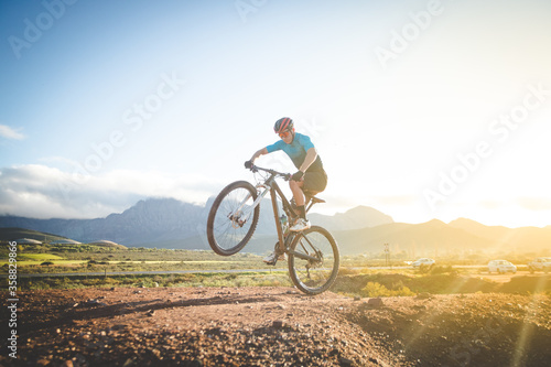 Fototapeta Naklejka Na Ścianę i Meble -  Close up image of a mountain biker speeding downhill on a mountain bike track