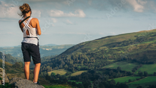 Female Traveler on the top of the mountain. Hiking. Landscape panorama, Pistyll Rhaeadr, Y Berwyn National Nature Reserve, Wales, United Kingdom, Europe