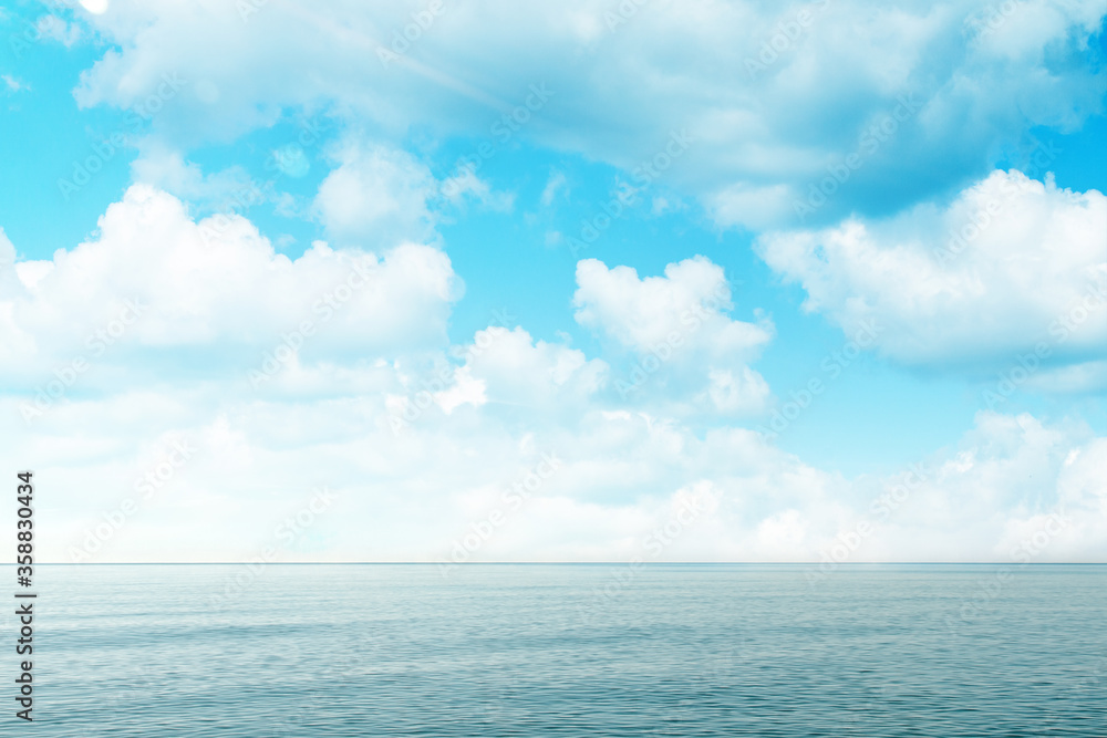 Blue sea and sky with clouds. Concept of world ocean day and conservation of the environment. Copy space
