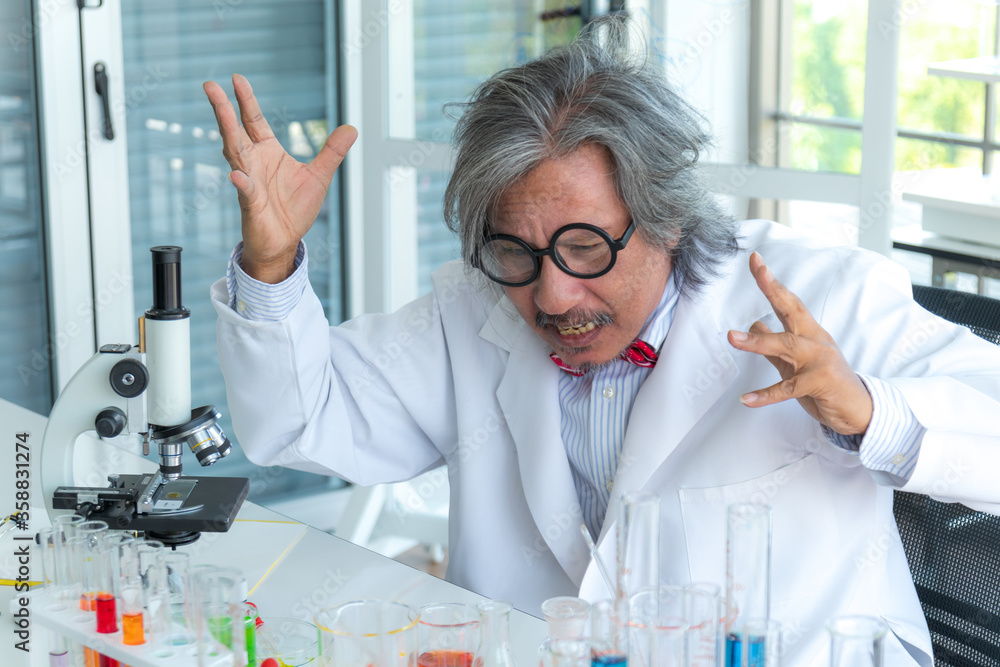 Senior male supervisor doing experiments and researchers working in the laboratory. Senior male supervisor doing experiments and researchers working in the laboratory.