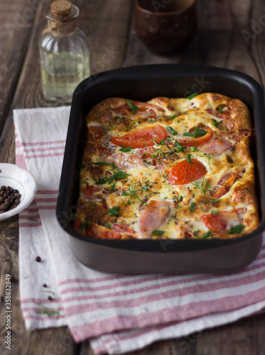 ham, tomato and cheese omelette in a baking dish