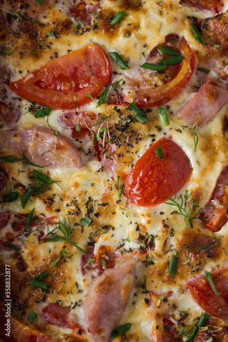 pizza with salami and olives. ham, tomato and cheese omelette in a baking dish