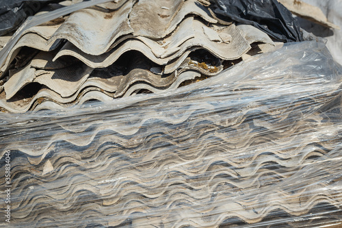 Asbestos landfill . Roof covering material with asbestos fiber . Asbestos roof removal . Dangerous asbestos dust and fiber in the environment . Health problems