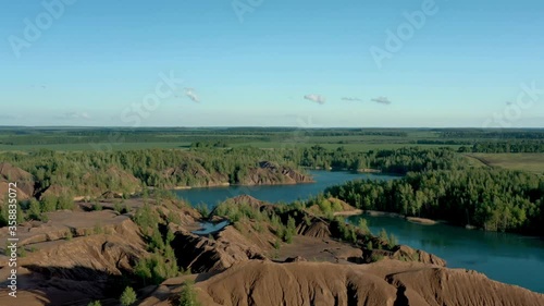 Romantsevo hills and lakes in Tula oblast drone aerial shot drone aerial zoom out. Fly over tulskaya oblast romantsevskie hills, konduki shot under cloudy blue sky photo