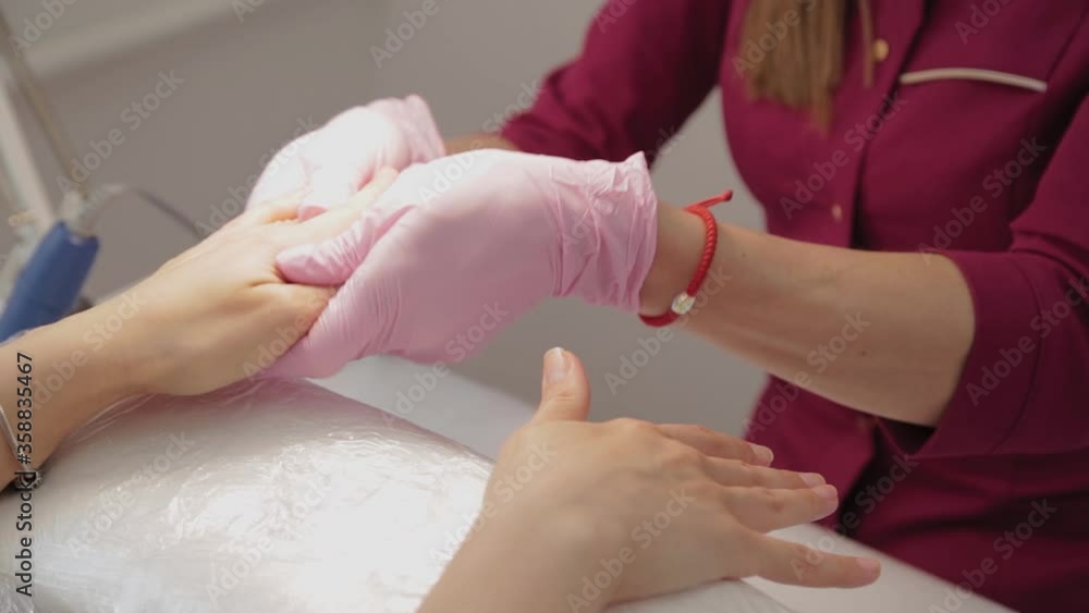 Manicurist disinfects the nails of the client. Manicurist disinfects the nails of the client.