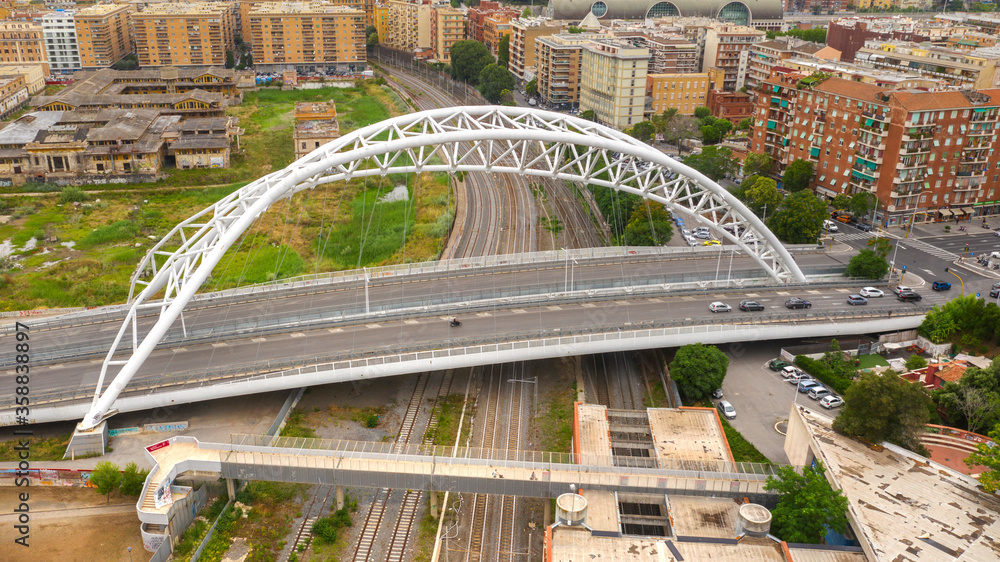 Fototapeta premium Aerial view of the Settimia Spizzichino bridge known as Ostiense overpass. This iron arch bridge is located in the Garbatella district in Rome, Italy