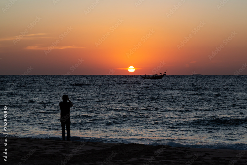 Arabian dhow in ocean at sunrise at Ras al Jinz in Oman