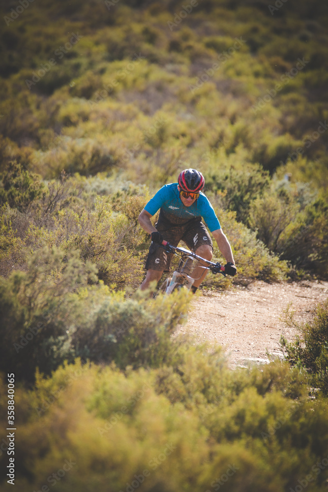 Close up image of a mountain biker speeding downhill on a mountain bike track