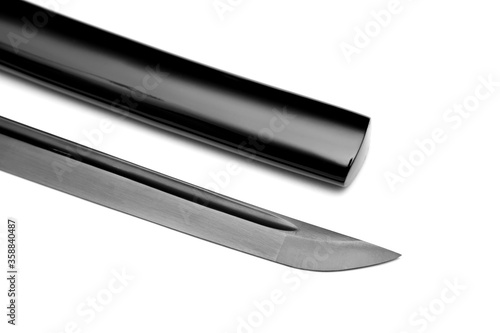 Close up Black blade Japanese sword with glossy black  scabbard on white background photo