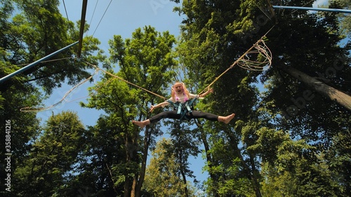 Slika na platnu Teenage girl jumping on the trampoline bungee.
