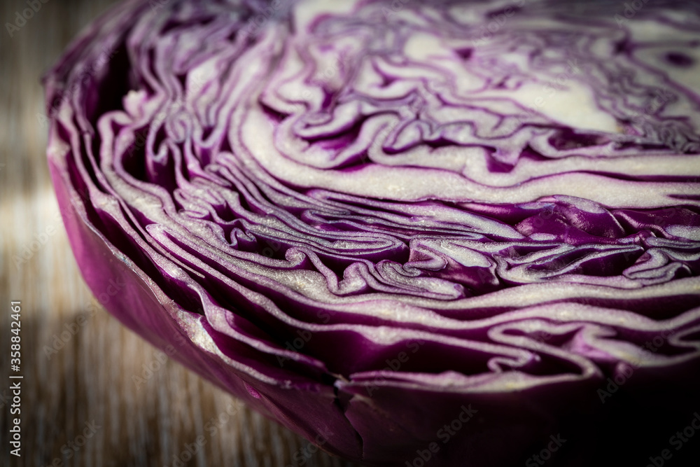 Fototapeta premium Purple cabbage lit on a wooden talbe.
