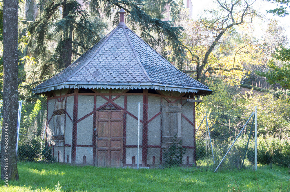 wooden pavilion surrounded by metal fence in the historic gardens of Campo del Moro in Madrid. Spain wooden pavilion surrounded by metal fence in the historic gardens of Campo del Moro in Madrid. Spain