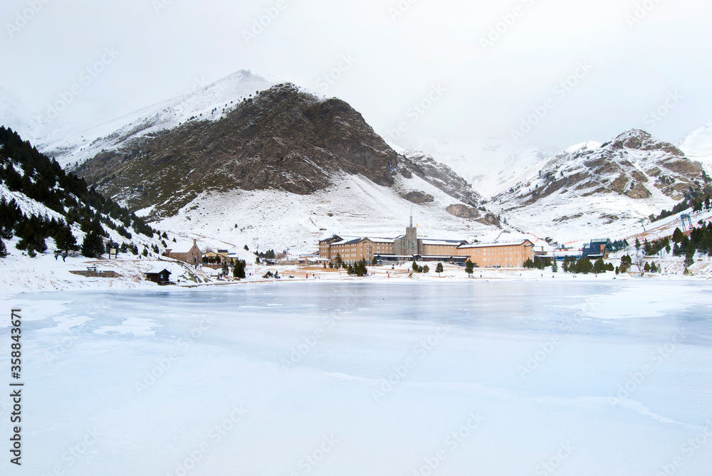 panoramic view of the Núria valley in winter. mountains lake and sanctuary.